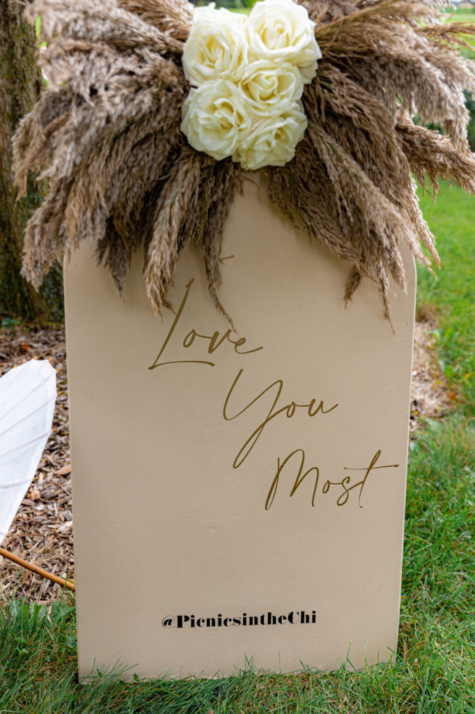 A sign that displays "Love You Most" created by Picnics in the Chi