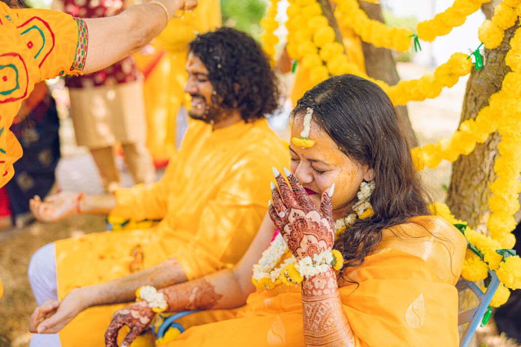An Indian couple partake in the Haldi before their wedding day.