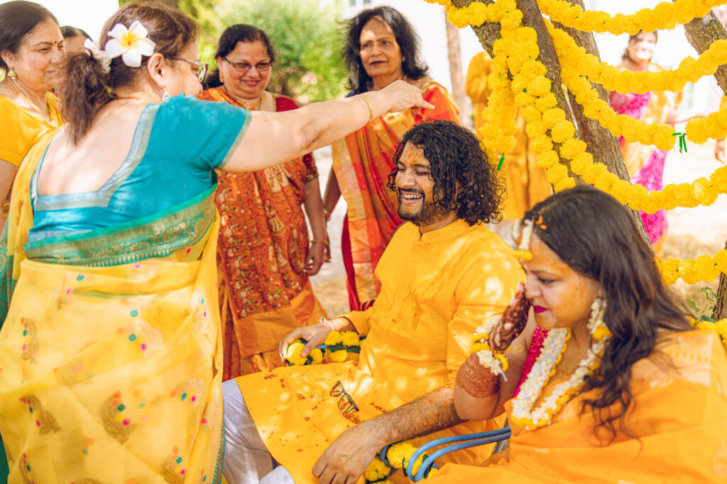 An Indian couple partake in the Haldi before their wedding day.