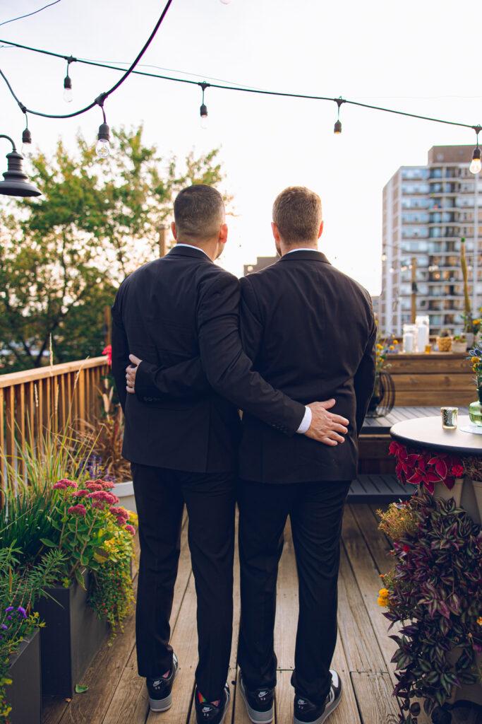A gay couple celebrates their wedding day at home with a DIY reception on their rooftop in Lakeview, Chicago.