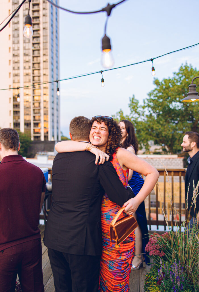 A gay couple celebrates their wedding day at home with a DIY reception on their rooftop in Lakeview, Chicago.