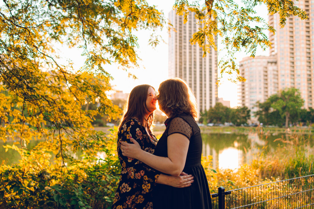 A queer couple poses for their engagement session at the North Pond in Lincoln Park, Chicago.