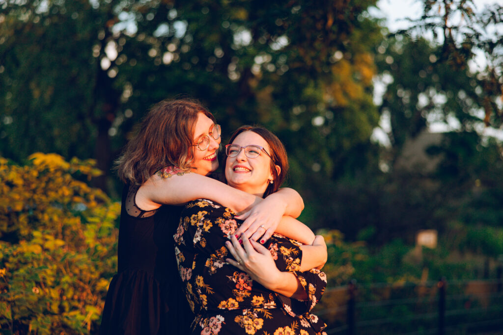 A queer couple poses for their engagement session at the North Pond in Lincoln Park, Chicago.