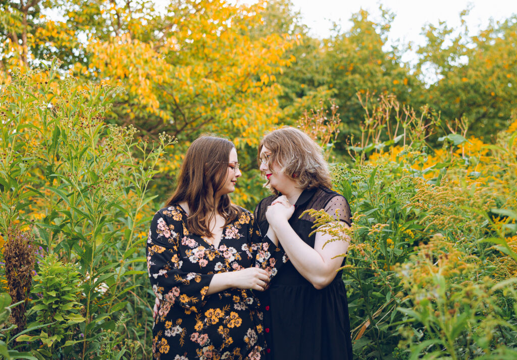 A queer couple poses for their engagement session at the North Pond in Lincoln Park, Chicago.