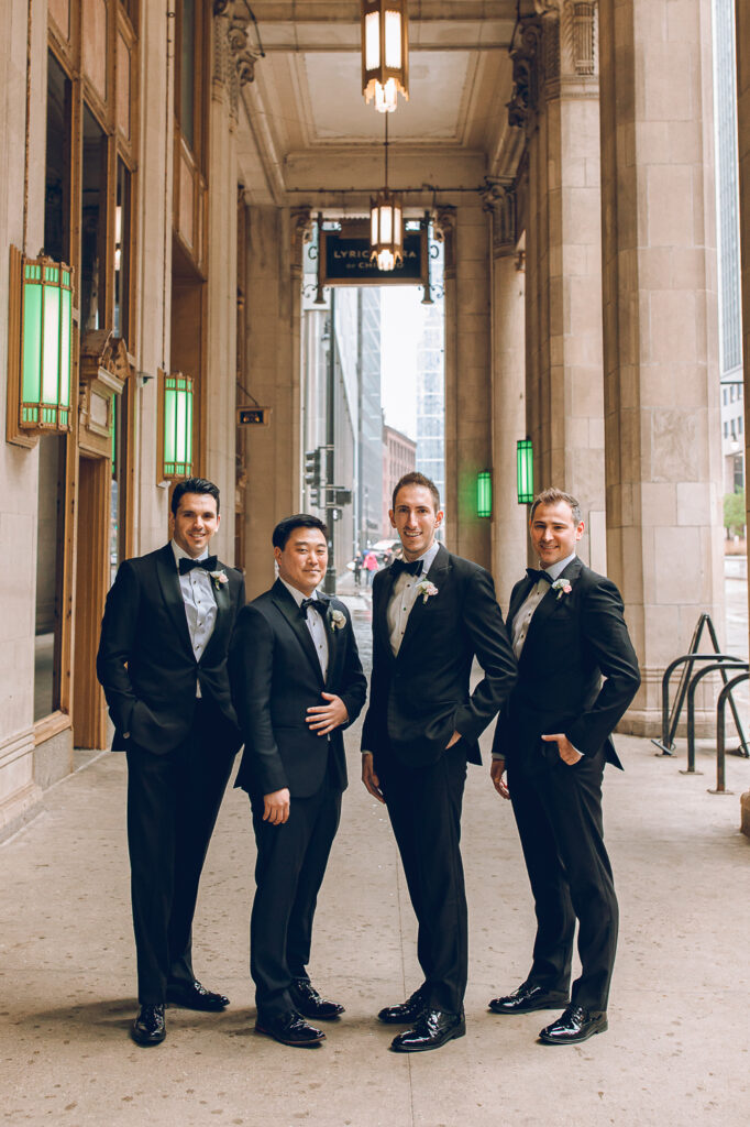 A wedding party under the Civic Opera Building in Chicago