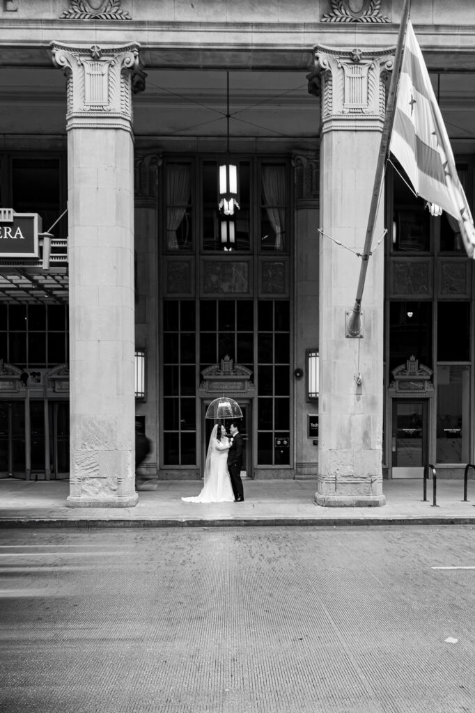A wedding party under the Civic Opera Building in Chicago