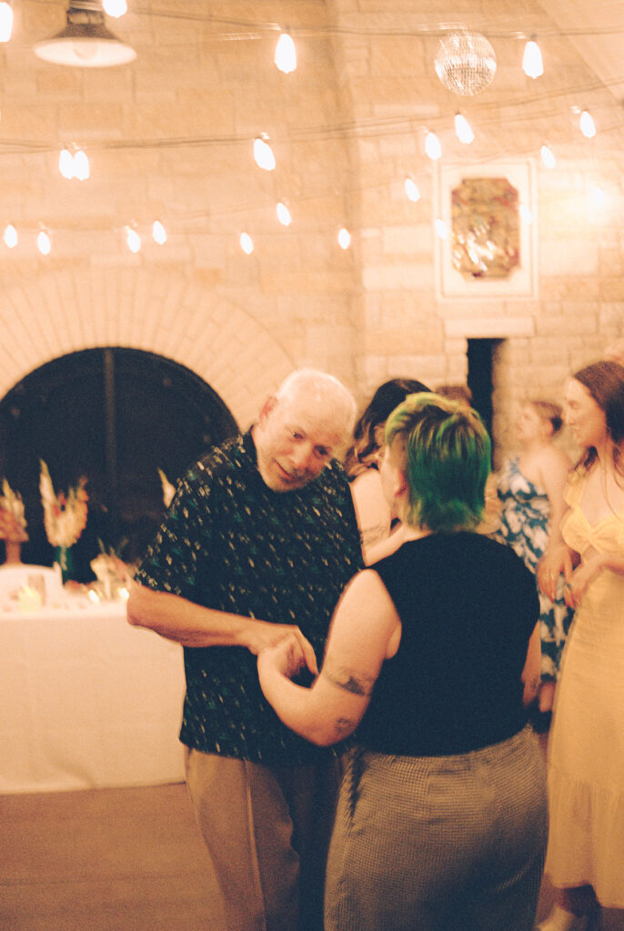 A queer couple celebrates their wedding at The Grove Redfield Estate in Glenview, Illinois.