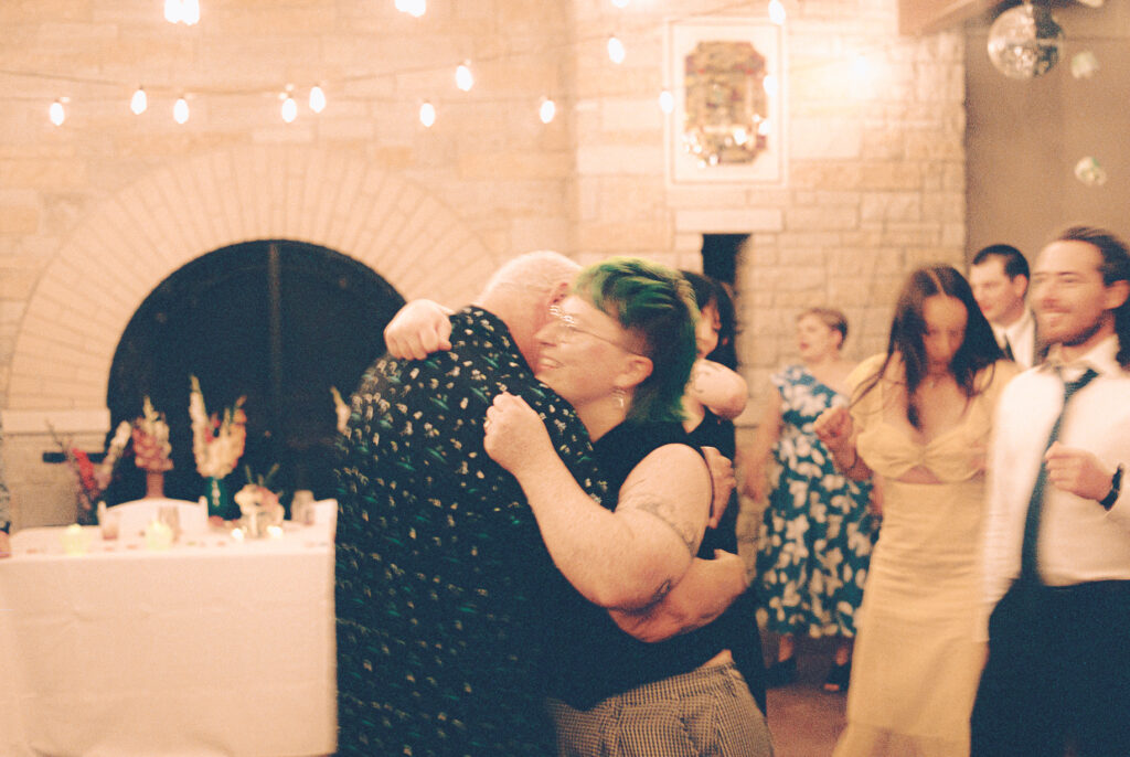 A queer couple celebrates their wedding at The Grove Redfield Estate in Glenview, Illinois.