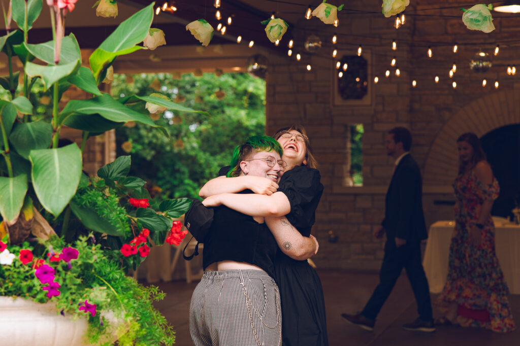 A queer couple celebrates their wedding at The Grove Redfield Estate in Glenview, Illinois.