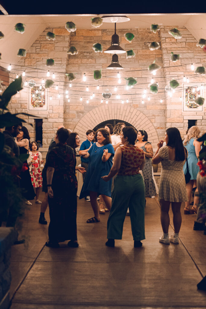 A queer couple celebrates their wedding at The Grove Redfield Estate in Glenview, Illinois.