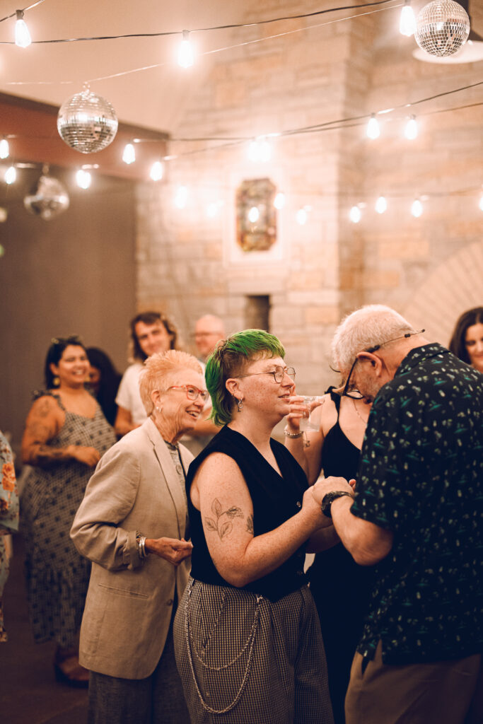 A queer couple celebrates their wedding at The Grove Redfield Estate in Glenview, Illinois.