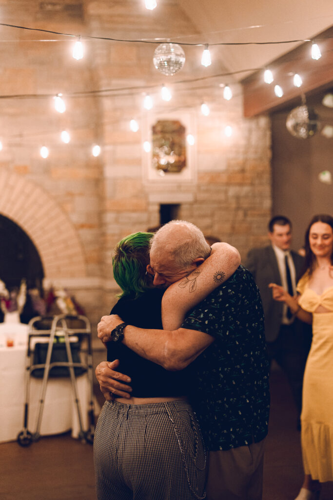 A queer couple celebrates their wedding at The Grove Redfield Estate in Glenview, Illinois.