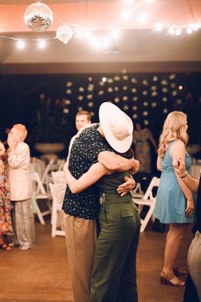 A queer couple celebrates their wedding at The Grove Redfield Estate in Glenview, Illinois.
